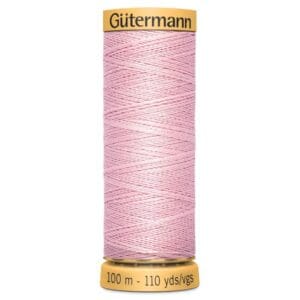 A spool of Gütermann pink sewing thread, labeled with "100 m - 110 yds/vgs" on the bottom, set against a white background.