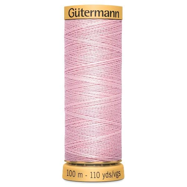 A spool of Gütermann pink sewing thread, labeled with "100 m - 110 yds/vgs" on the bottom, set against a white background.