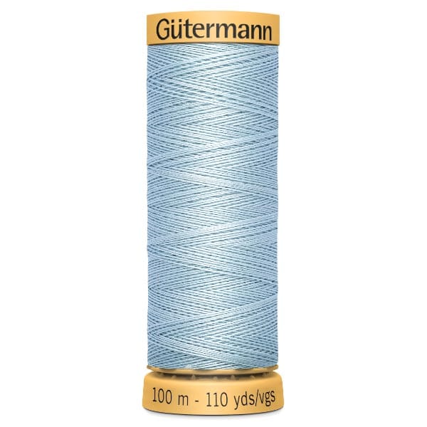 A spool of Gütermann thread, featuring light blue polyester sewing thread. The spool displays the brand name at the top and indicates a length of 100 meters or 110 yards at the bottom.