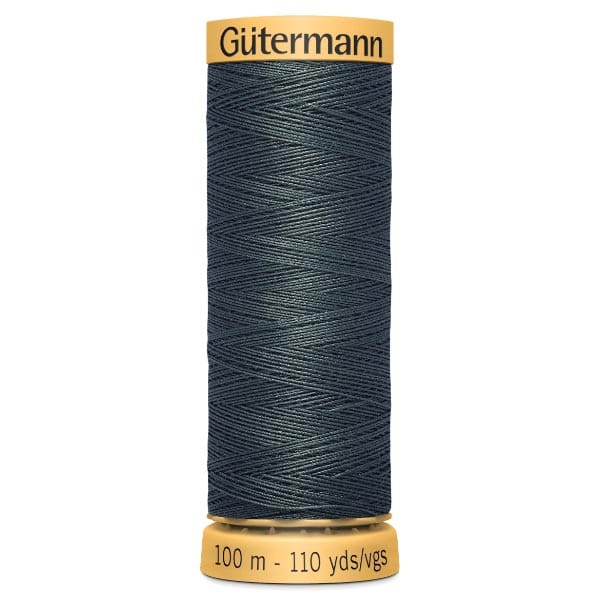 A spool of Gütermann dark green sewing thread, labeled with "100 m - 110 yds" on the bottom and "Gütermann" on the top. The thread is neatly wound in a criss-cross pattern.