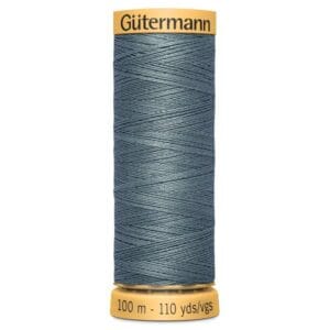 A spool of Gütermann thread in a teal shade with a golden top and bottom. The label shows 100 meters or 110 yards of thread.