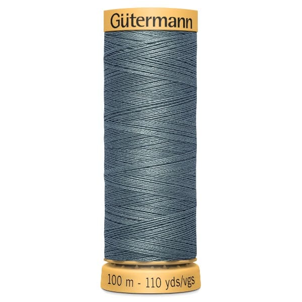 A spool of Gütermann thread in a teal shade with a golden top and bottom. The label shows 100 meters or 110 yards of thread.