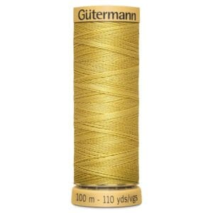 A spool of Gütermann sewing thread in golden yellow. The spool label indicates a length of 100 meters or 110 yards. The thread is neatly wound around the spool, showing a shiny surface.