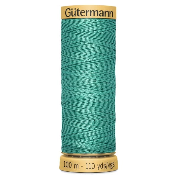 A spool of Gütermann thread in turquoise color, labeled with "100 m - 110 yds" at the base. The top label displays the brand name. The thread is neatly wound around the spool.