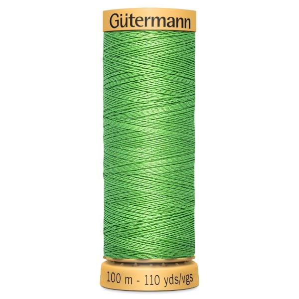 Spool of Gütermann thread in bright green. The label shows 100 meters or 110 yards. The spool has a yellow top and bottom.