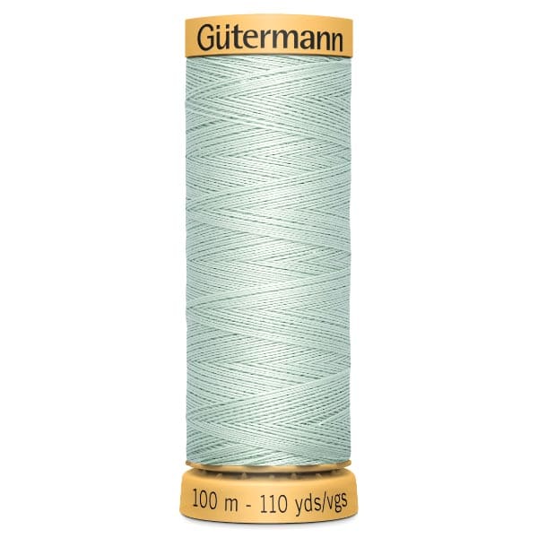 A spool of Gütermann sewing thread, light green in color, with a yellow cap and base. The spool is labeled with thread length of 100 meters or 110 yards.