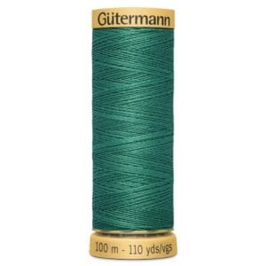 Spool of Gütermann green sewing thread, labeled as 100 meters/110 yards. The spool has a yellow base and top, displaying the brand name and thread length.