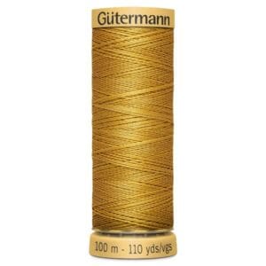 A spool of Gütermann golden brown polyester thread, 100 meters or 110 yards, shown upright. The thread is densely wound, with the brand name on the top edge and length details on the bottom edge of the spool.