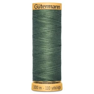 A spool of Gütermann sewing thread in dark green. The spool is yellow with text indicating 100 meters (110 yards) of thread.