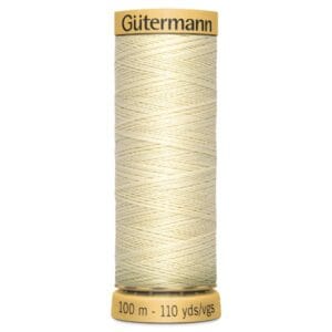 A spool of Gütermann thread, wrapped with light beige sewing thread. The label indicates the length of 100 meters or 110 yards. The spool is cylindrical with a yellow cap and base.