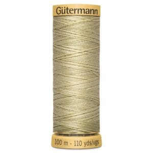 A spool of Gütermann thread in a light beige color. The spool holds 100 meters or 110 yards of thread and has a yellow label at the top and bottom.