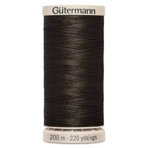 A spool of Gütermann black sewing thread, labeled for 200 meters or 220 yards. The thread is tightly wound around a white spool with labeling on top and bottom.