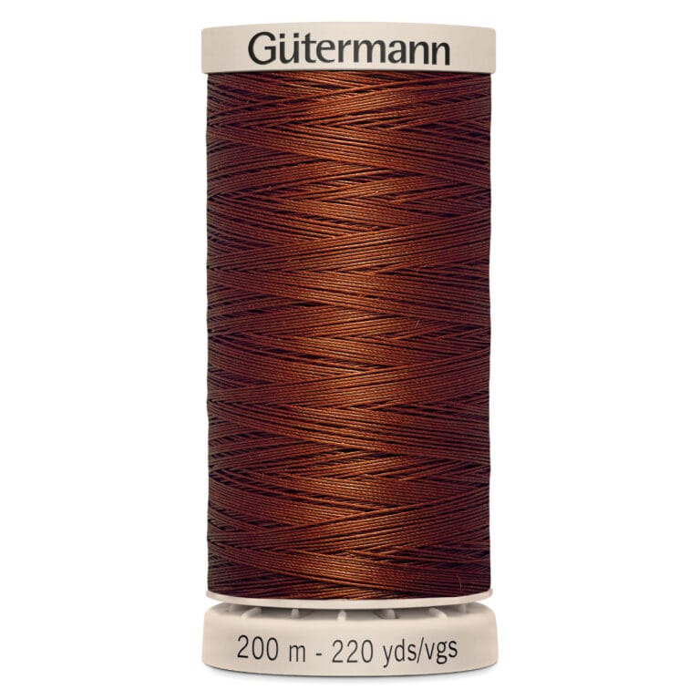 A spool of Gütermann thread, colored in a rich brown hue. The label indicates the length as 200 meters or 220 yards. The spool features a light beige top and bottom with the brand name on the top.