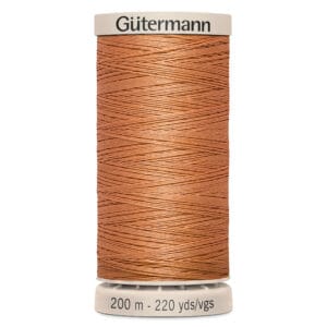 A spool of Gütermann sewing thread in a rich copper color, labeled with 200 meters or 220 yards. The spool has a cream-colored top and bottom.