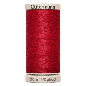 A spool of Gütermann thread in vibrant red. The spool is marked with "200 m - 220 yds/vgs" and features a beige top and bottom. The thread is neatly wound around the spool.