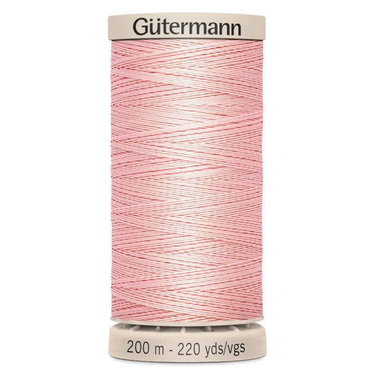 A spool of Gütermann thread in light pink with white stripes. The spool displays "200 m - 220 yds/vgs" on the base.