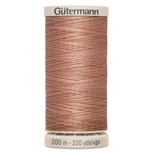 A spool of Gütermann sewing thread with a tan color. The top and bottom are labeled, indicating 200 meters and 220 yards of thread.