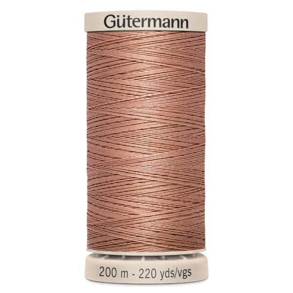 A spool of Gütermann sewing thread with a tan color. The top and bottom are labeled, indicating 200 meters and 220 yards of thread.