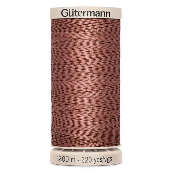 A spool of Gütermann sewing thread in a shade of brown is displayed. The spool includes labels indicating the length as 200 meters or 220 yards.