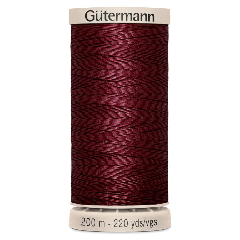 A spool of Gütermann thread in deep red. The label reads "200 m - 220 yds/vgs.