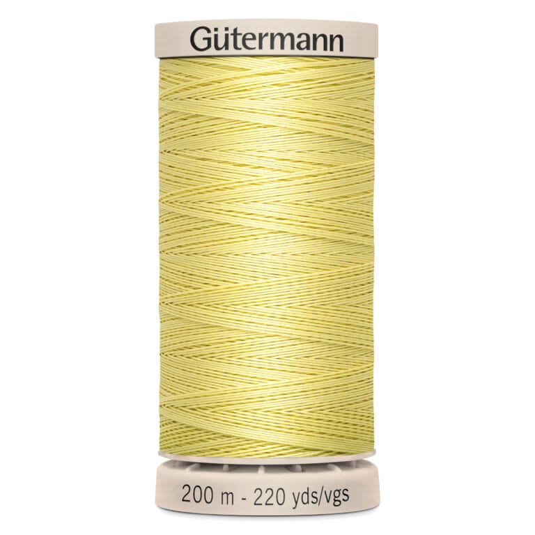 A spool of Gütermann sewing thread in light yellow, labeled with "200 m - 220 yds/vgs." The spool has a beige top and bottom with the brand name at the top. The thread is neatly wound around the spool.