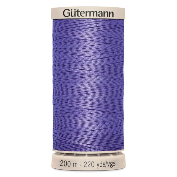 A spool of Gütermann thread with purple thread wound around it. The label on the bottom indicates it is 200 meters or 220 yards long.