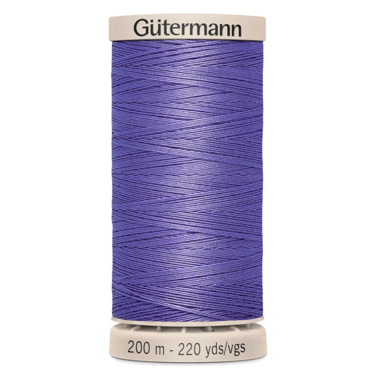 A spool of Gütermann thread with purple thread wound around it. The label on the bottom indicates it is 200 meters or 220 yards long.