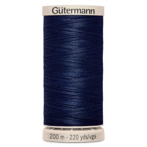 Spool of Gütermann dark blue sewing thread labeled "200 m - 220 yds/vgs," with a cream top and base.