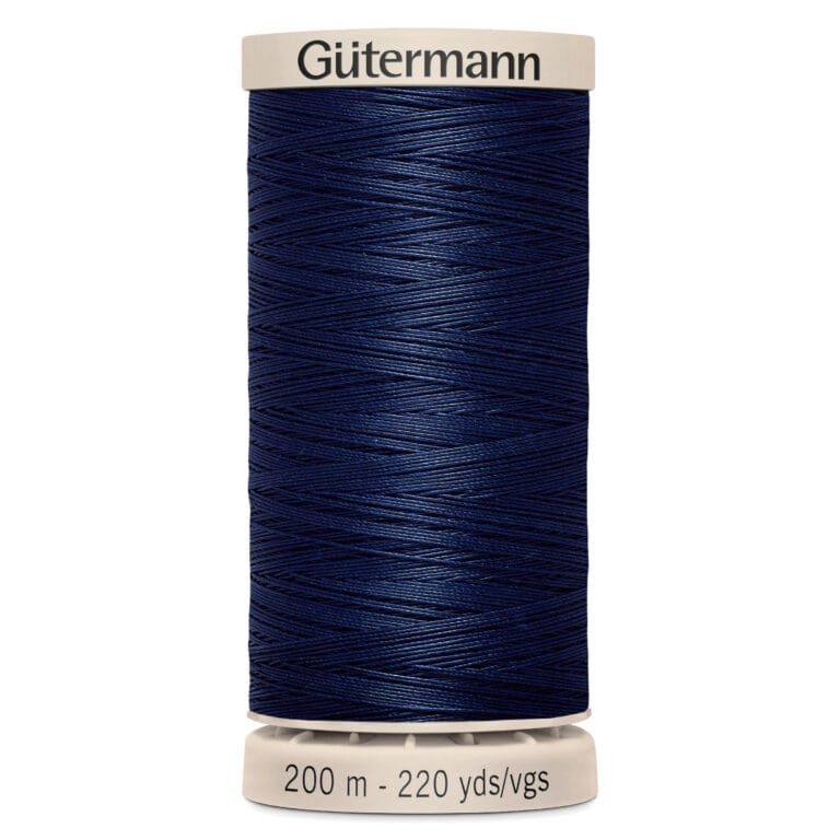 Spool of Gütermann dark blue sewing thread labeled "200 m - 220 yds/vgs," with a cream top and base.