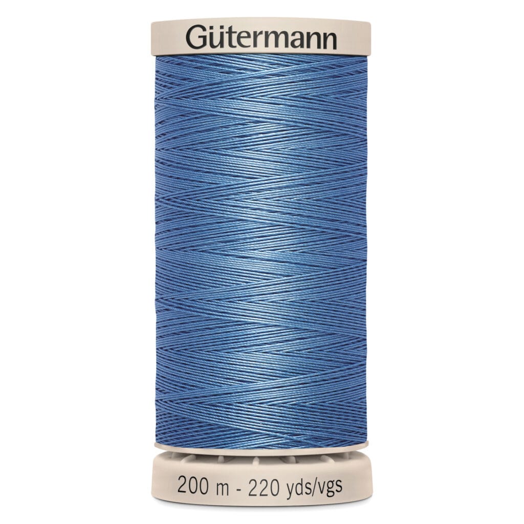 A spool of Gütermann sewing thread in blue. The label indicates the length as 200 meters or 220 yards.