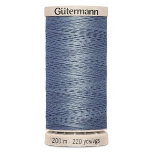 A spool of Gütermann thread in a shade of blue, wrapped neatly around the spool. The text at the base reads "200 m - 220 yds/vgs.