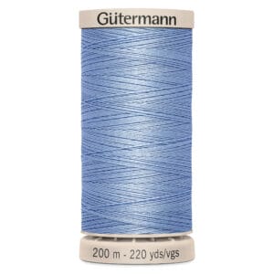 A spool of blue Gütermann thread is shown vertically, wrapped neatly around a beige base. The label reads "200 m - 220 yds/vgs.