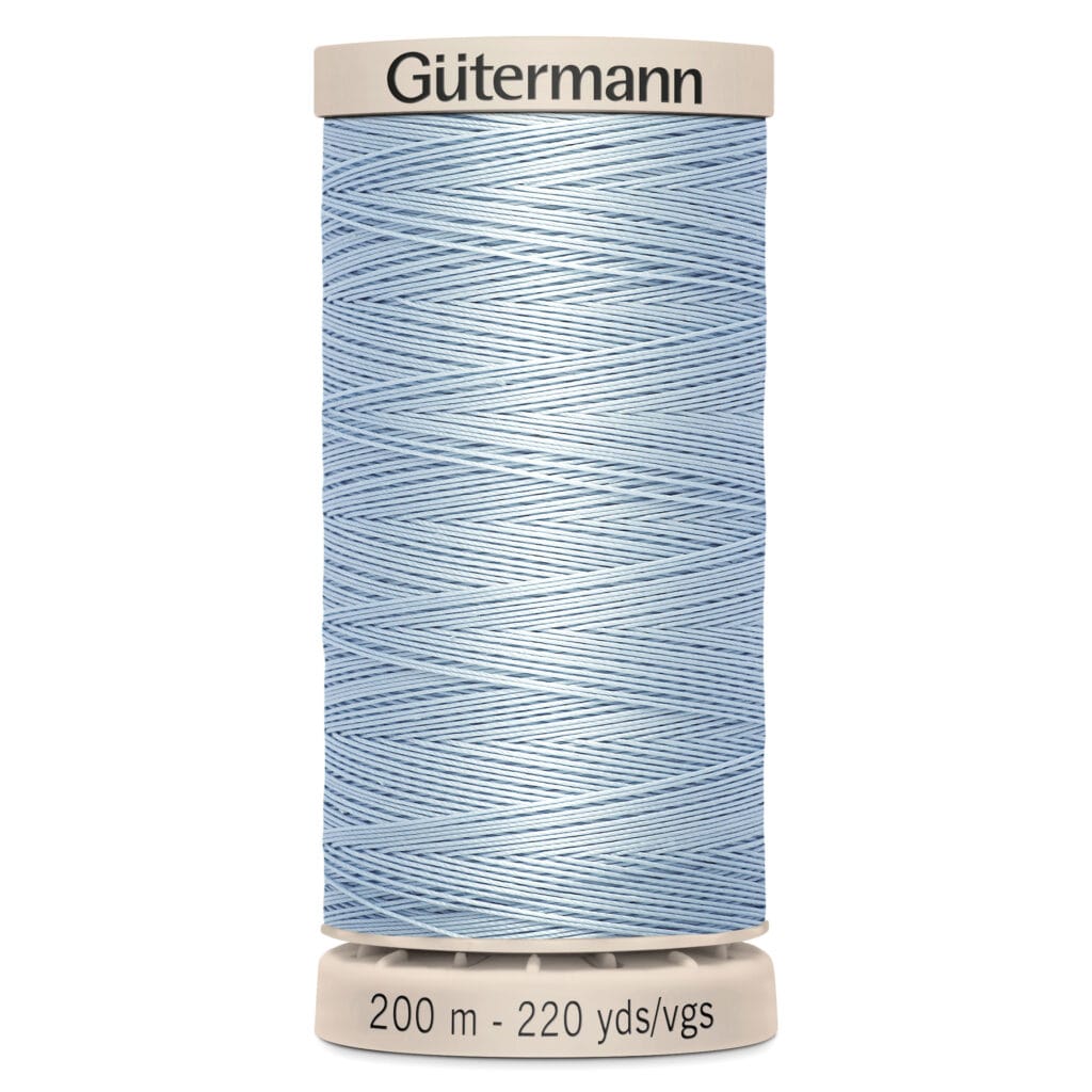 A spool of light blue Gütermann sewing thread, labeled with a length of 200 meters or 220 yards. The spool is white with coordinating cap and base.