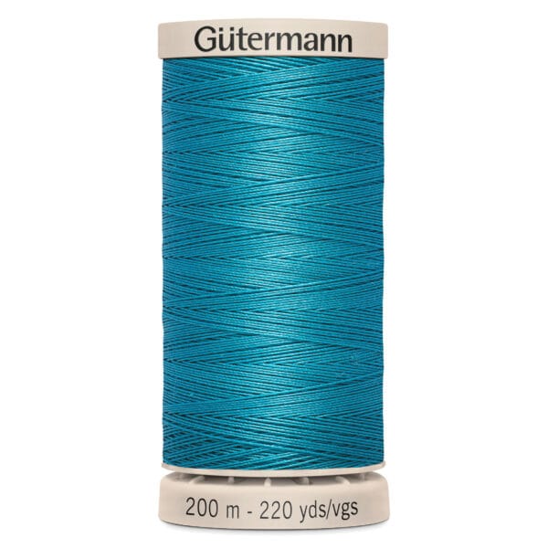 A spool of Gütermann thread in vibrant turquoise. The spool shows measurements of 200 meters and 220 yards.