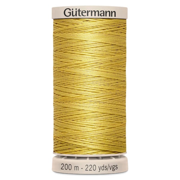 A spool of Gütermann polyester thread in a golden yellow color, with a label indicating it's 200 meters and 220 yards long. The spool is vertically positioned, with a beige base and top.