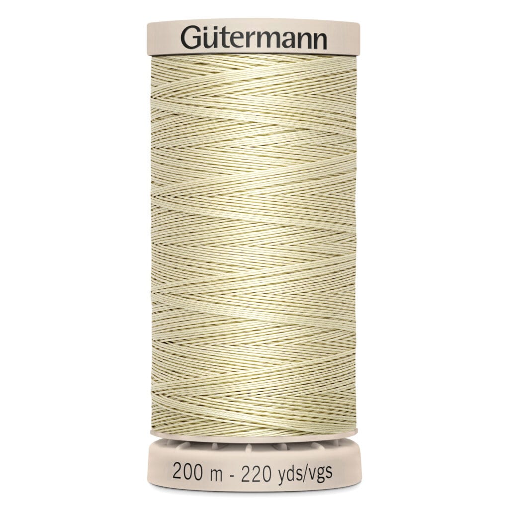 A spool of Gütermann thread with light beige color, featuring neatly wound thread. The base reads "200 m - 220 yds/vgs.
