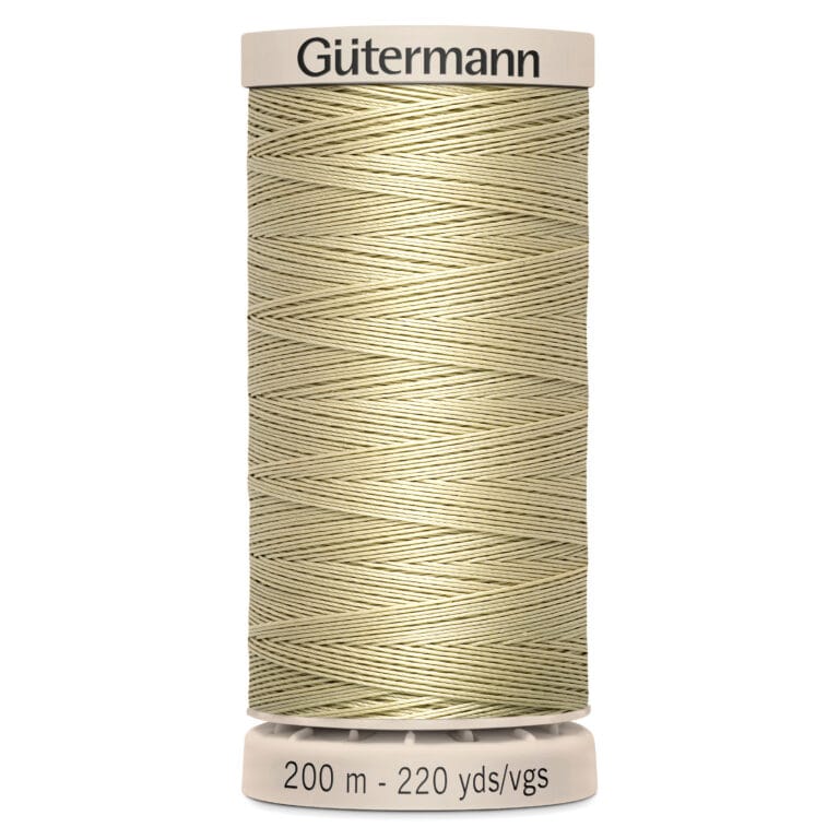 A spool of Gütermann thread in a light beige color. The label at the top displays the brand name, and the bottom indicates the length as 200 meters or 220 yards. The thread is neatly wound on a cylinder.