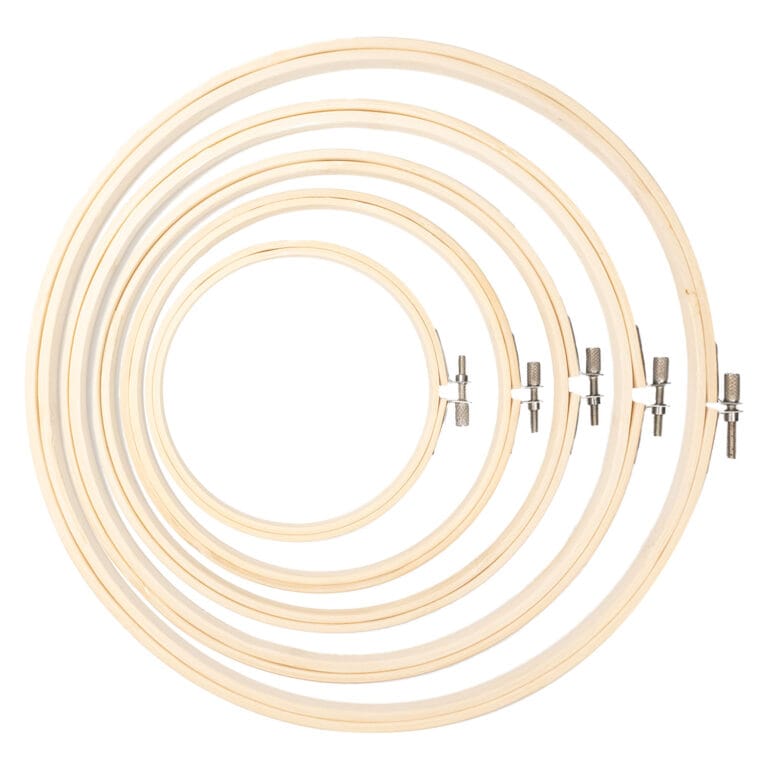 Six Wooden Embroidery Hoops from the "Wooden Embroidery Hoop | Embroidery Frame" set, fanned out to display varying sizes and a natural wood finish. Metal screws for tension adjustment are visible against a white background, with hoops subtly overlapping to highlight their circular shape.