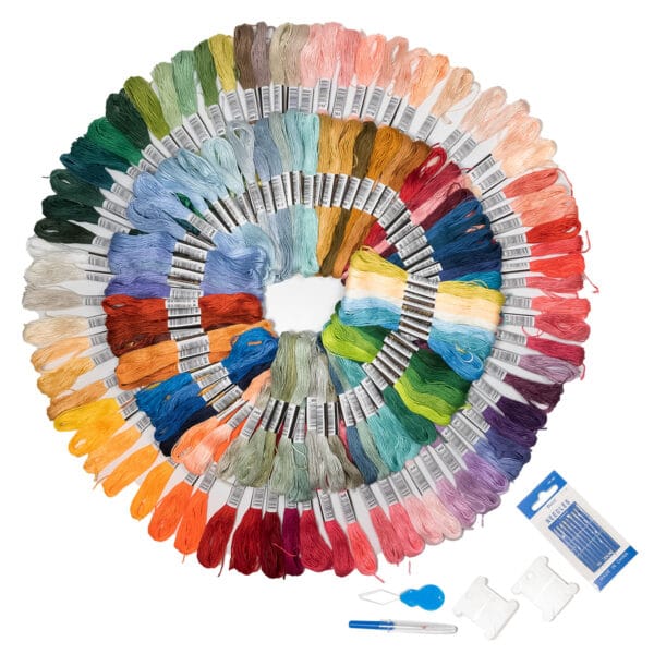 A spiral arrangement of colorful embroidery floss in various shades, ranging from greens and blues to reds and yellows. Accompanying the thread are embroidery tools including needles, a needle threader, and organizers.