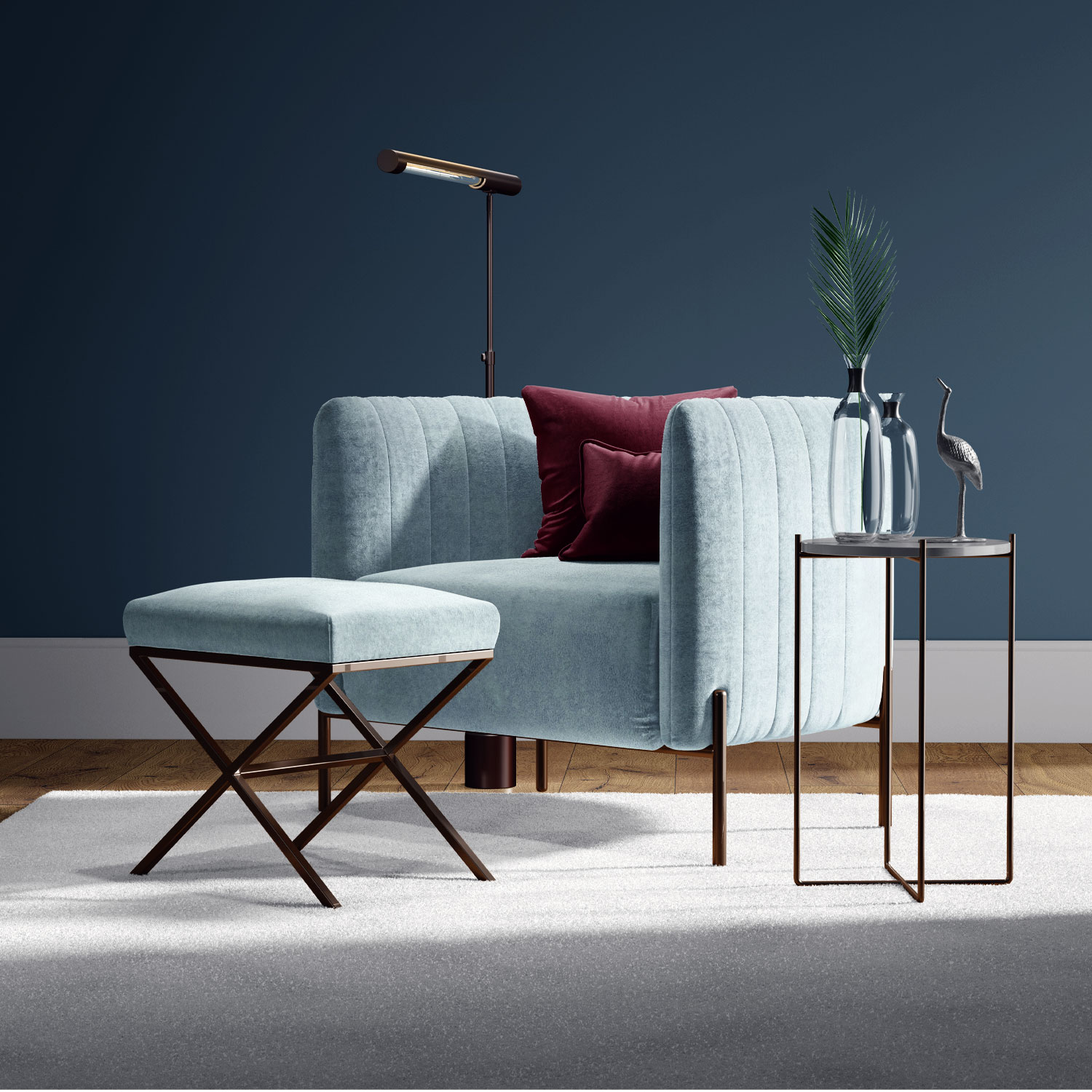 A modern living room with a light blue armchair, matching ottoman, floor lamp, and a side table holding vases with palm leaves and a decorative bird statue, set against a dark blue wall.
