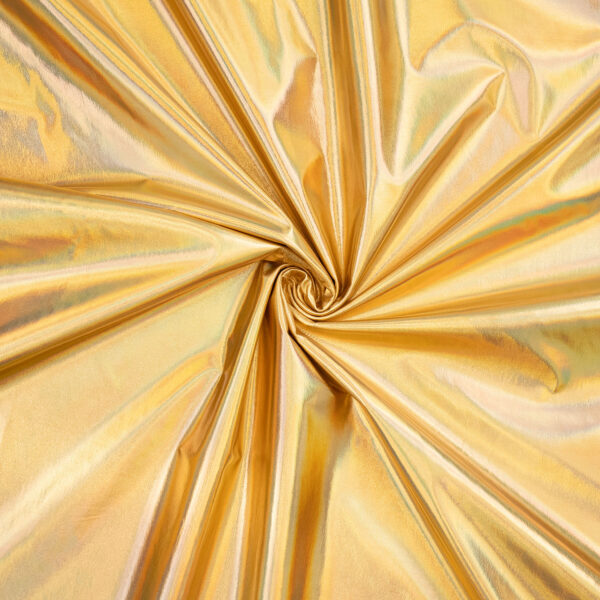 Shiny gold metallic fabric arranged in loose folds with a spiral twist in the center, creating reflective and textured surfaces.