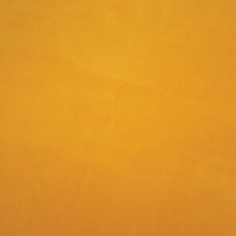 Solid orange surface with a soft, slightly textured appearance and minimal visible variation in color or pattern.