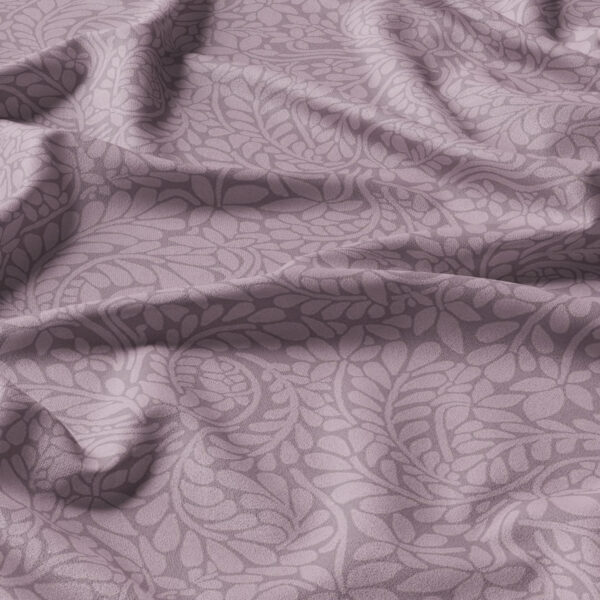 Soft purple fabric with a subtle, intricate leaf and floral pattern, shown with natural folds and gentle shadows highlighting its texture and design.