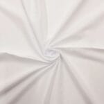 White fabric twisted into a centered spiral, creating soft folds radiating outward. The smooth material has a clean and crisp appearance, emphasizing the texture and flow of the cloth.