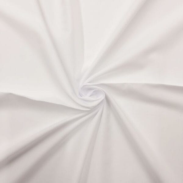 White fabric twisted into a centered spiral, creating soft folds radiating outward. The smooth material has a clean and crisp appearance, emphasizing the texture and flow of the cloth.