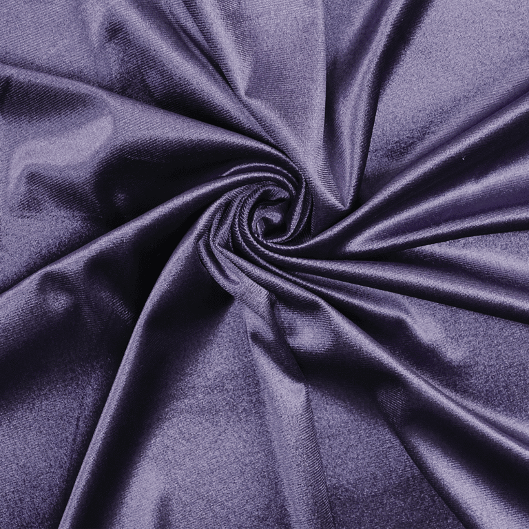 A close-up of shiny, deep purple fabric gathered in gentle folds and twisted at the center, creating a swirling, textured pattern with highlights and shadows.