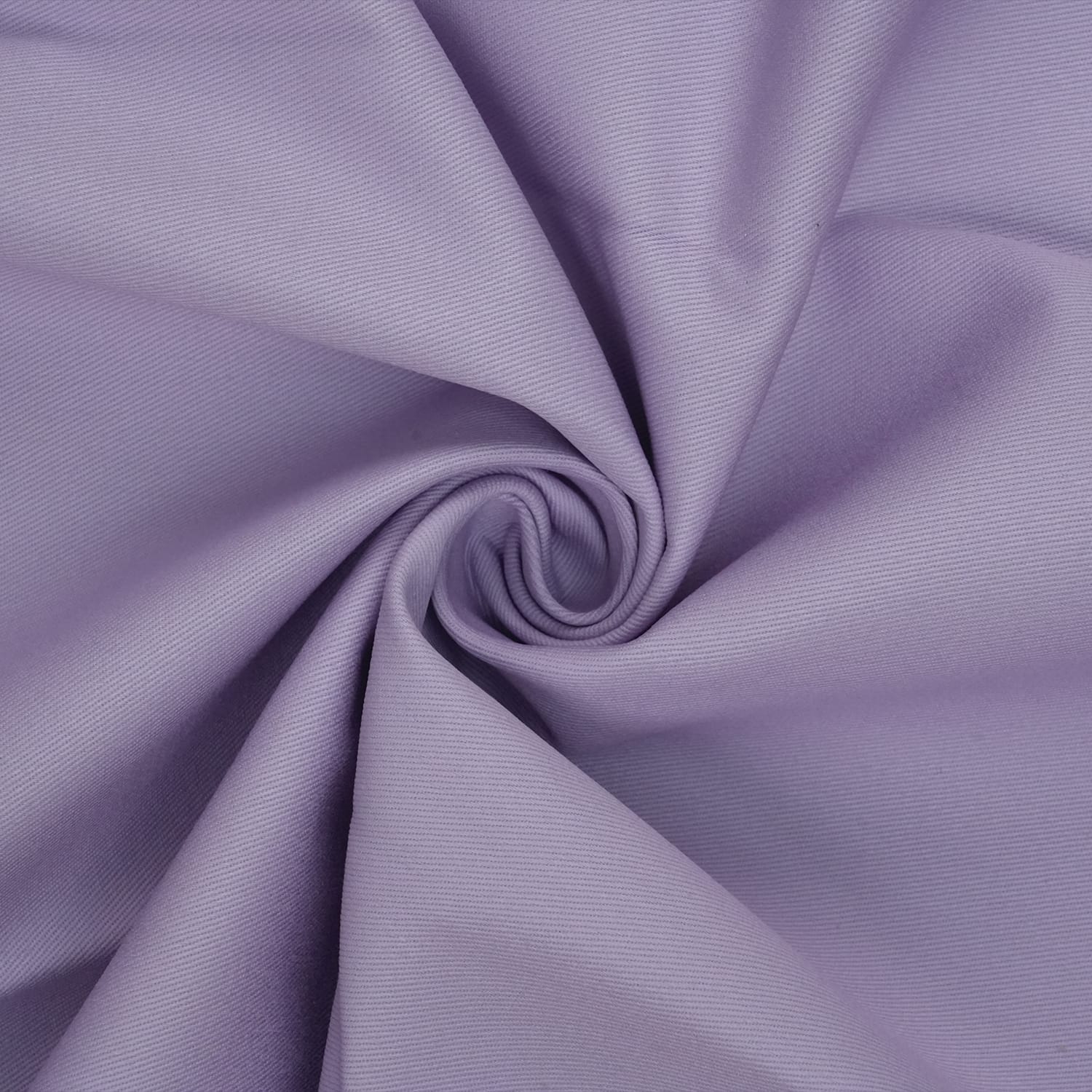 Cotton-Drill-Lilac-2 A close-up of light purple fabric twisted into a spiral, showing a smooth texture and soft folds radiating from the center.
