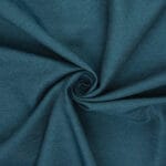 Teal fabric with a smooth texture is gathered in the center, creating a swirling, spiral pattern with visible folds and creases.