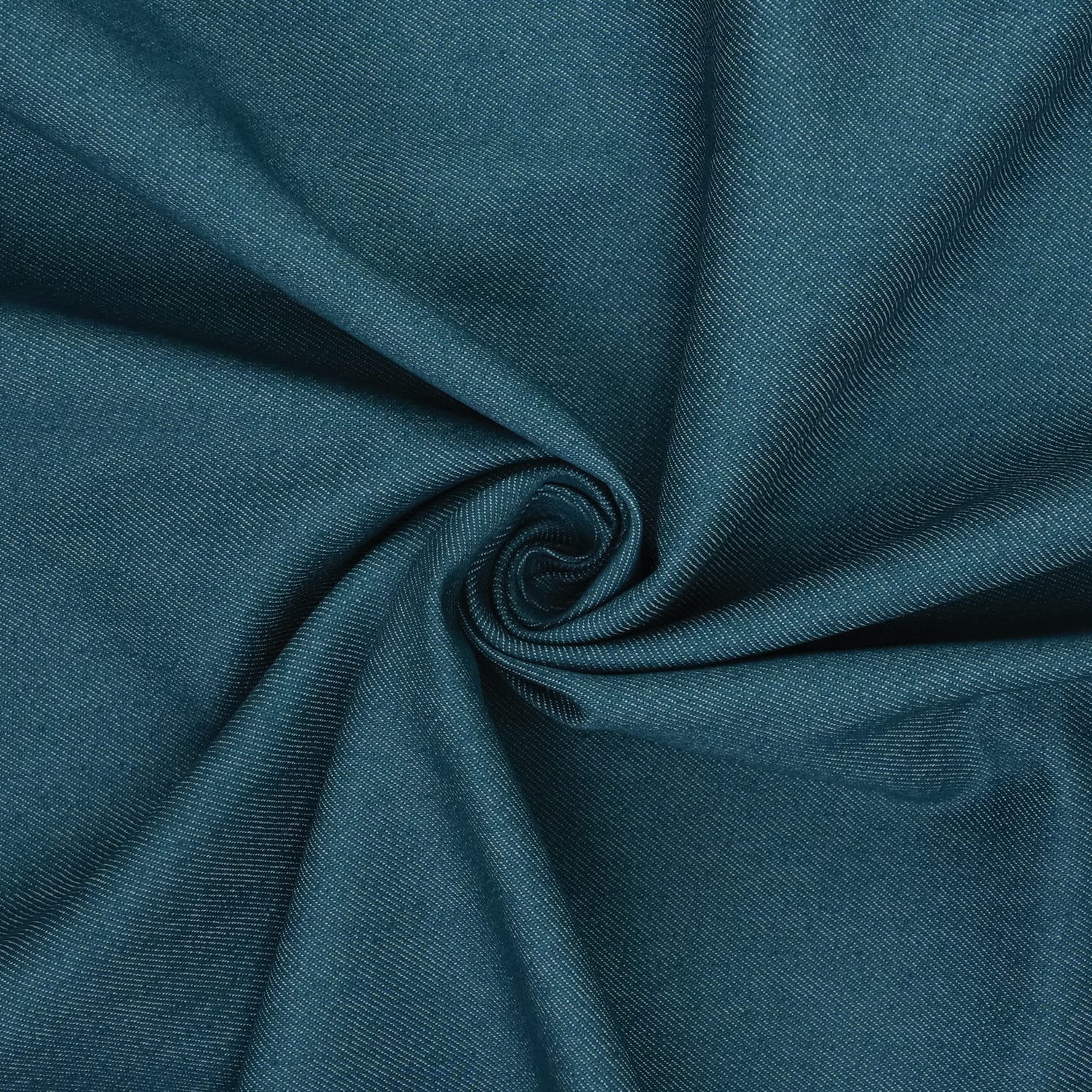 Jeans-Denim-Indigo-Petrol-3 Teal fabric with a smooth texture is gathered in the center, creating a swirling, spiral pattern with visible folds and creases.
