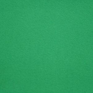 A close-up view of a green felt surface, showing its soft, textured fabric. The color is solid and even throughout the image.